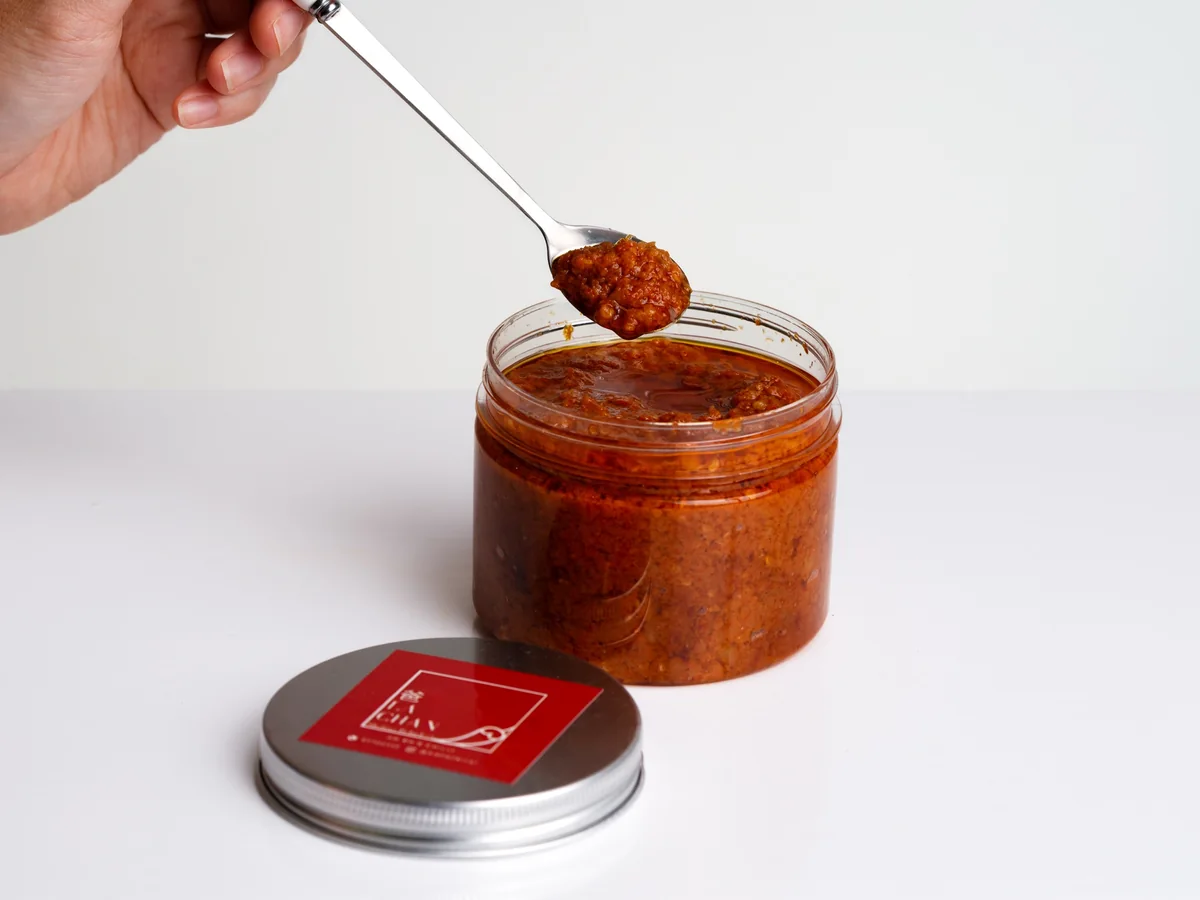 A spoonful of Sambal Belacan lifted from the jar
