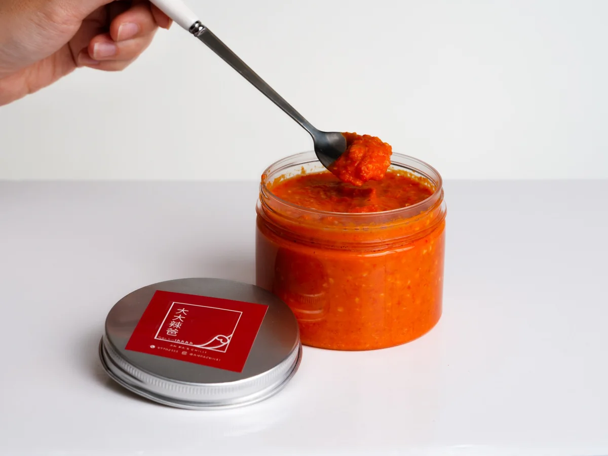 A spoonful of signature chilli lifted from the jar